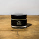 Muscle Butter USA 30ml arnica recovery balm jar with black lid on wooden surface